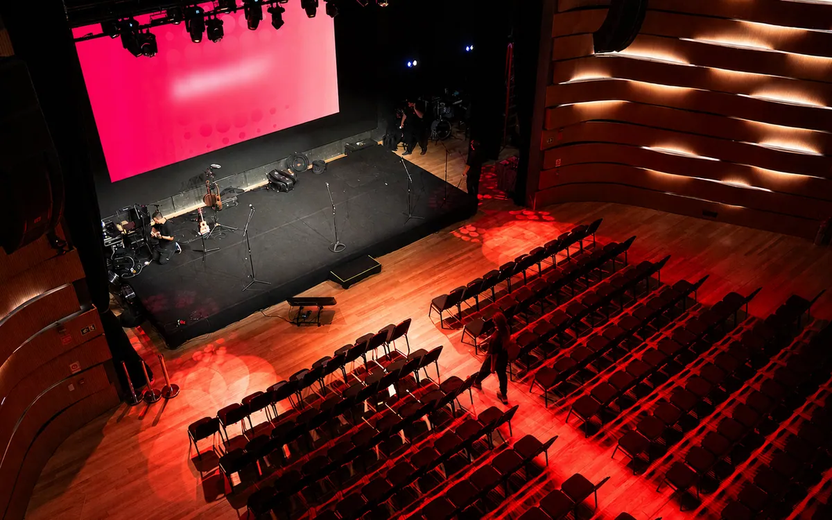 Palco e plateia vistos do alto, em iluminação vermelha